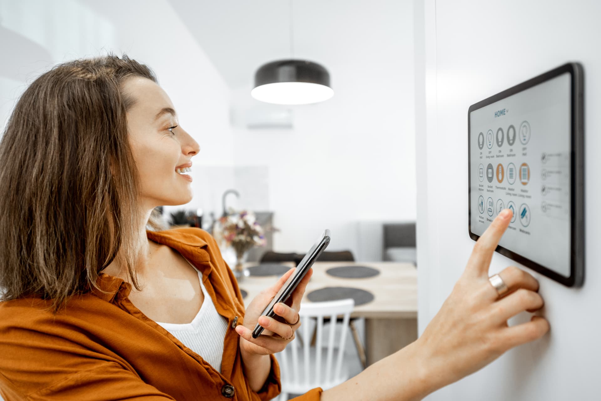 Woman controlling a smart home system with her phone